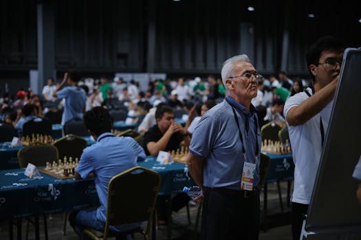 A bustling indoor chess tournament with players deeply focused on their games.