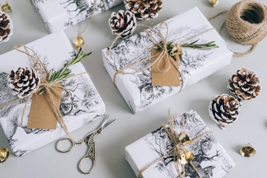 Beautifully wrapped Christmas gifts with pine cones, bells, and rustic elements in a flat lay composition.